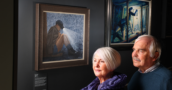 man and woman looking at paintings inside The Mining Art Gallery, Bishop Auckland